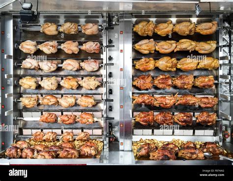 Rotisserie chicken being cooked on a spit