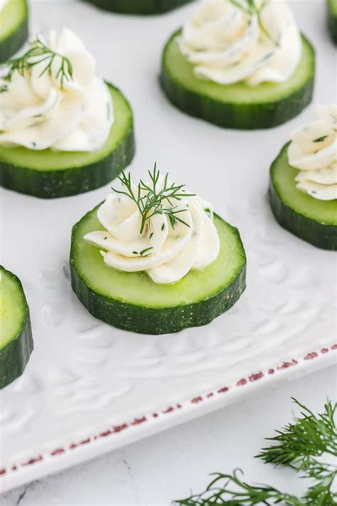 Assortment of elegant French canapés with cucumber garnish