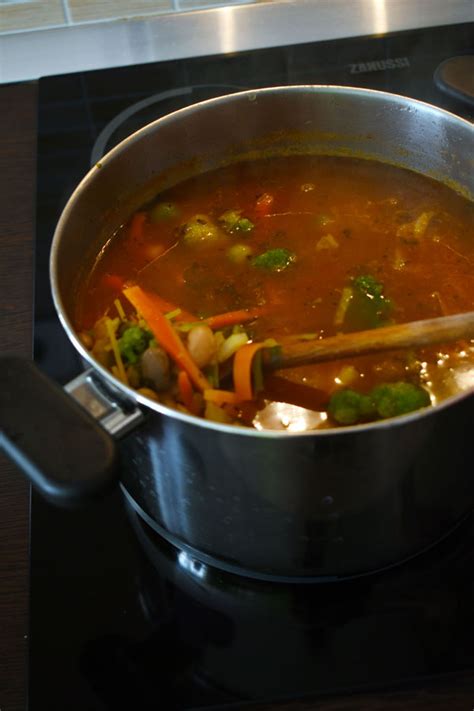 Leves alapjának főzése fazékban, benne bab, paradicsom és zöldpaprika