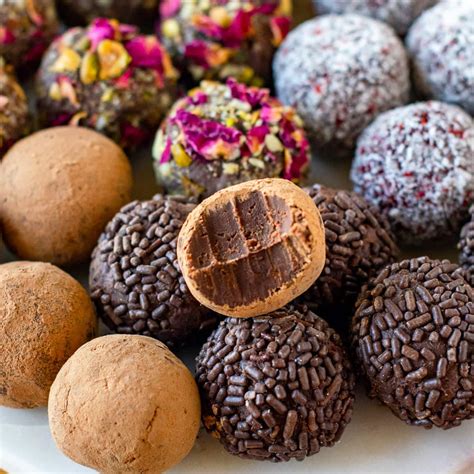 Assortment of artisan chocolates and truffles, some clearly showing ganache fillings