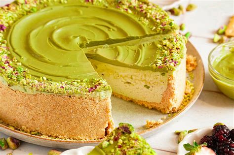 Pistachio cheesecake slice with a bite taken out, showing creamy texture