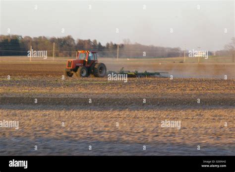 Tractor pulling machine on a field