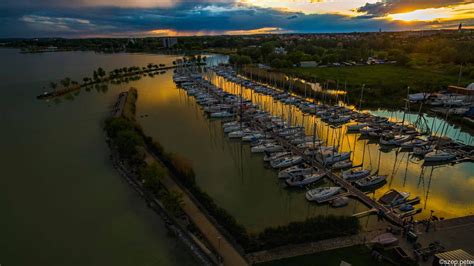A Balaton látképe, naplementekor, halászhajóval
