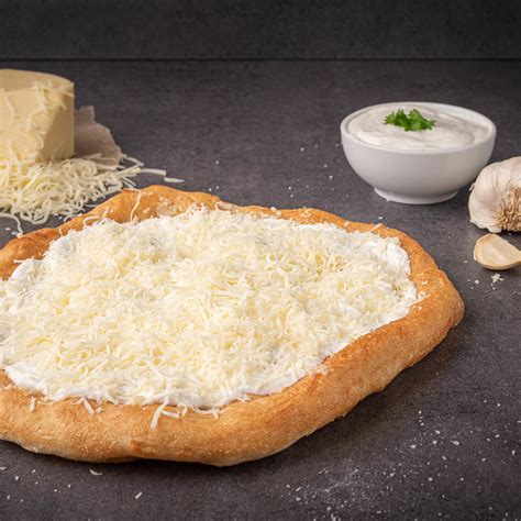 Lángos tányéron, fokhagymás tejföllel és sajttal