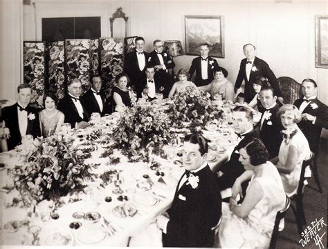 People in 1920s attire at a themed dinner table