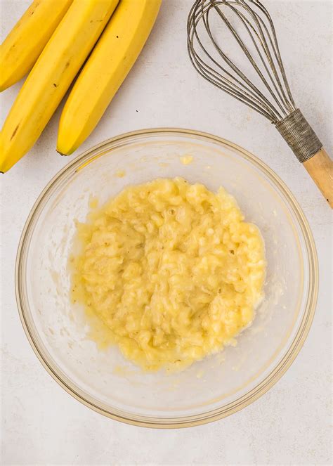 Bowl of mashed bananas, coconut flakes, and collagen powder ready for mixing