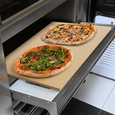 Homemade pizza baking on a pizza stone in the oven