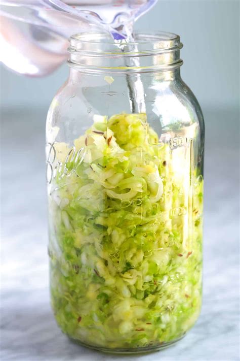 pressing cabbage into a jar