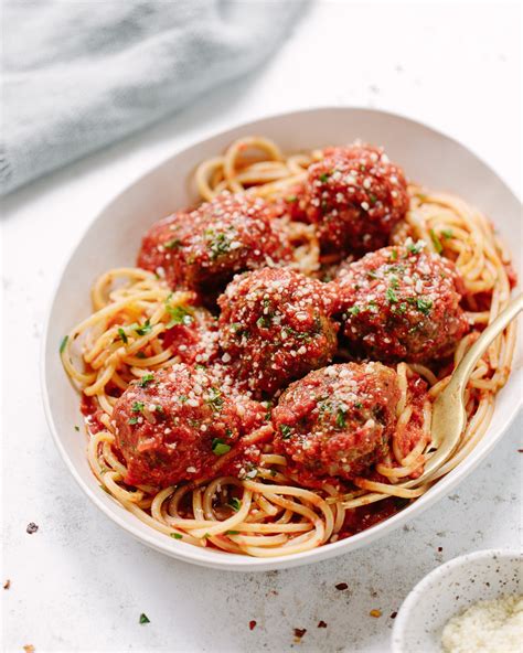 A large plate of spaghetti with giant meatballs, contrasting Italian and American culinary styles