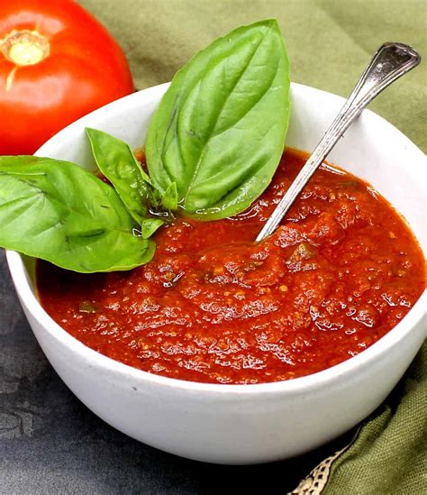Ingredients for a rich tomato sauce: fresh tomatoes, herbs, onion, garlic