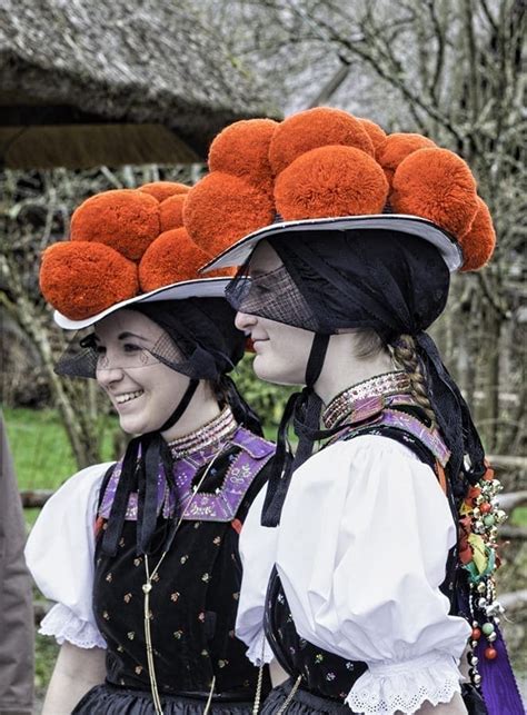 Black Forest traditional Bollenhut costume compared to the layers of the cake