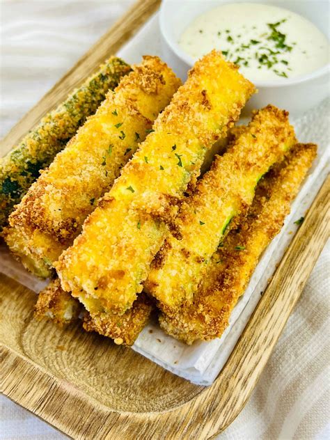 Zucchini sticks baking in an oven on a tray