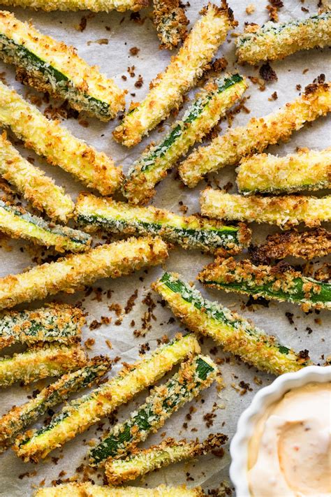 A plate of crispy oven-baked zucchini fries with herbs