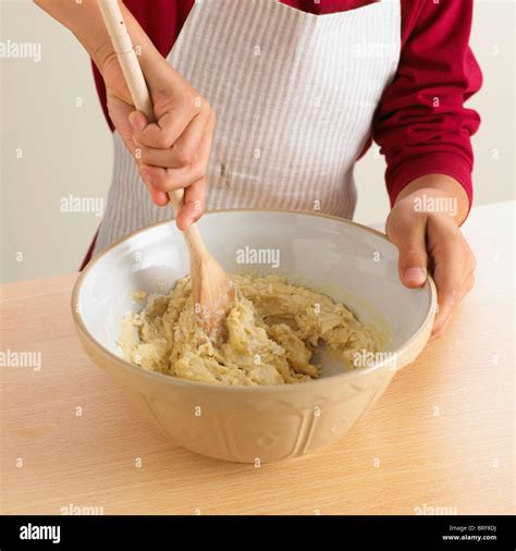 Mixing cake batter with a wooden spoon