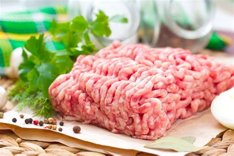 friss, kiváló minőségű darált sertéshús a vágódeszkán fűszerekkel