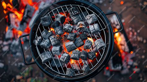A glowing charcoal grill with food