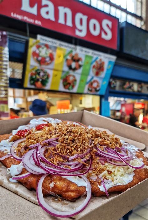 A wide selection of lángos toppings and various roasted meats