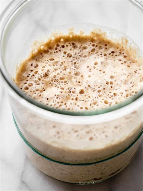 Sourdough starter in a jar with bubbles