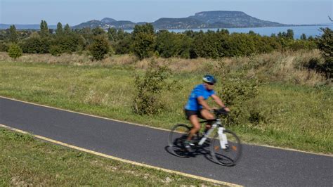 Balatoni kerékpárút részlete, háttérben a tóval és hegyekkel