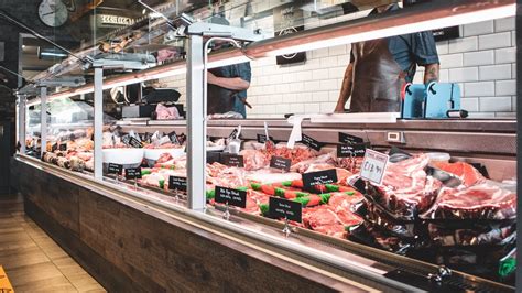 Comparison of small butcher shop and supermarket meat counter