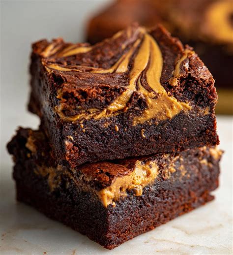 Slices of peanut butter brownie generously drizzled with extra peanut butter and sprinkled with coarse sea salt