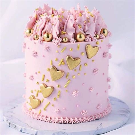 Pink birthday cake with various decorations